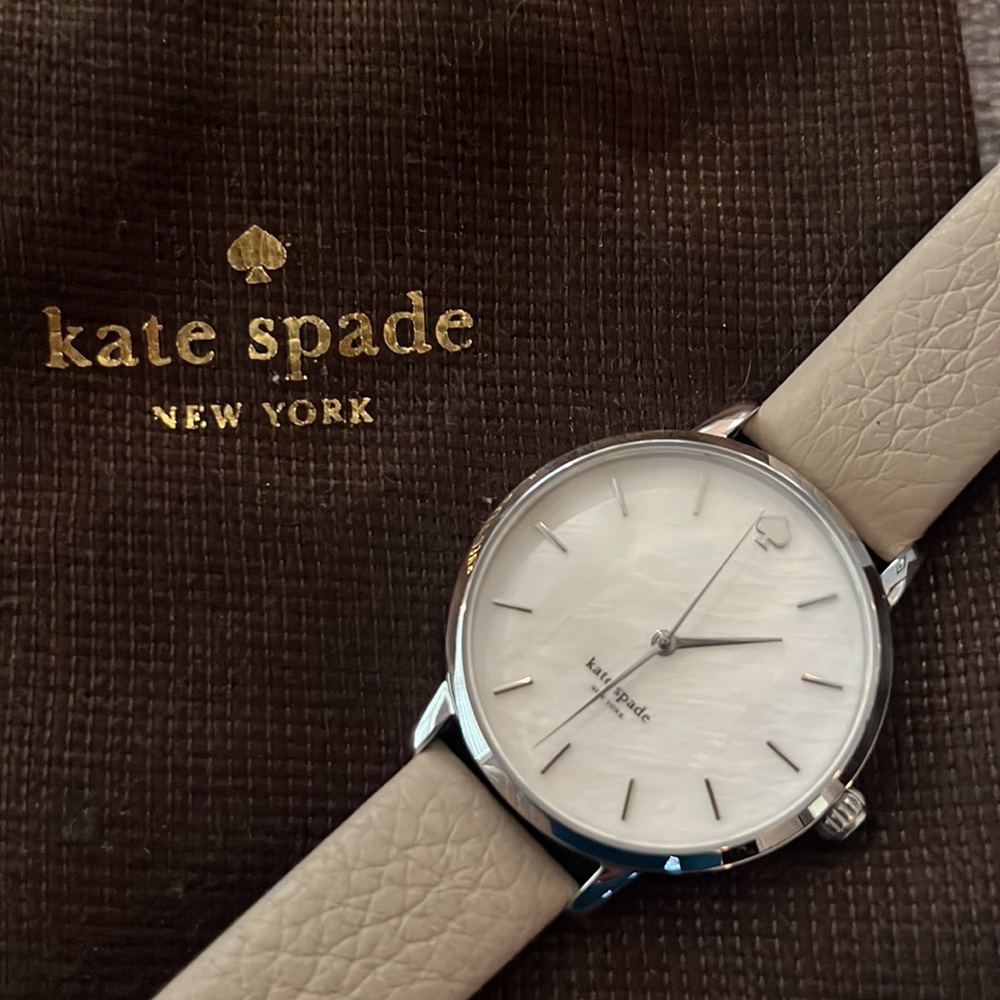 Kate Spade beige strap watch with silver bezel and buckle.